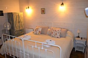 a bedroom with a white bed with towels on it at Lofts del Mercado in Villa La Angostura