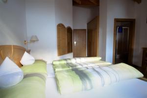 A bed or beds in a room at Pension Mirandola