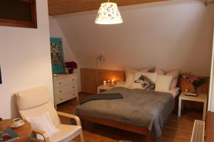 a bedroom with a bed and a table and a chair at Willa Mitia in Zakopane