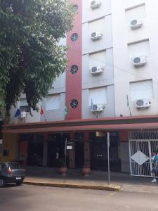 a building with a car parked in front of it at Turis Hotel in Santo Ângelo