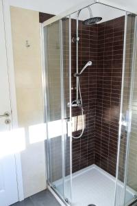 a shower with a glass enclosure in a bathroom at Family House in Lisbon