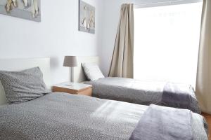 a bedroom with two beds and a window at Family House in Lisbon