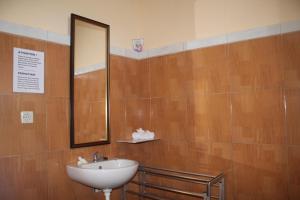 a bathroom with a sink and a mirror at Summer Guesthouse Lovina in Lovina +49 photos