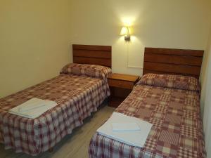 A bed or beds in a room at Apartamentos Olympia Center