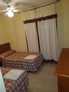 A bed or beds in a room at Apartamentos Olympia Center