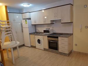 A kitchen or kitchenette at Apartamentos Olympia Center