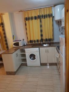 A kitchen or kitchenette at Apartamentos Olympia Center
