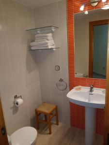 a bathroom with a sink and a toilet and a mirror at Apartamentos Olympia Center in La Manga del Mar Menor