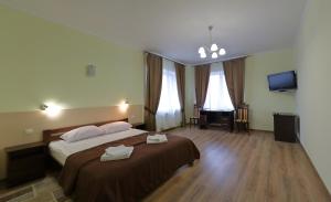 Postel nebo postele na pokoji v ubytování Hotel Karpaty