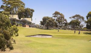 a group of people playing golf on a golf course at Twiggy @ Anglesea in Anglesea