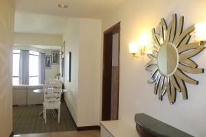 a living room with a mirror on the wall at FnF Suite @ Time Square in Kuala Lumpur