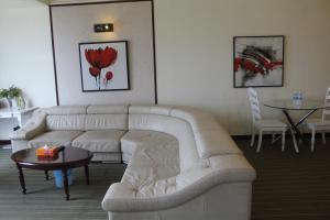 a living room with a white couch and a table at FnF Suite @ Time Square in Kuala Lumpur