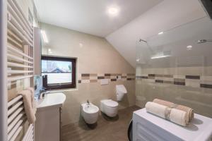 a bathroom with a sink and a toilet at Lake Bled Apartment Zerovec in Bled