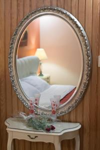 a mirror on a table in a room at Xenonas Epavli in Levidi