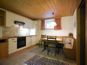 a kitchen with a table and a dining room at Pension Seeberger in Wald am Arlberg