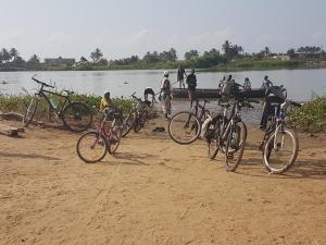 a group of bikes parked on a beach near a body of water at Ramaya Auberge Espagnole in Grand-Popo +41 photos