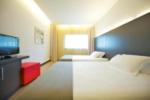 Posteľ alebo postele v izbe v ubytovaní Mercure Nerocubo Rovereto