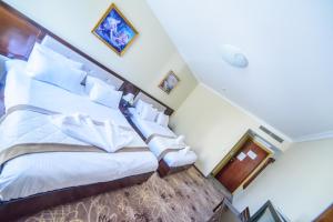 Postel nebo postele na pokoji v ubytování Sancta Maria Hotel