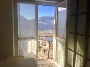 a room with a view of a balcony with a table at Casa Lampone in Trento