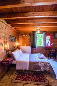 a bedroom with a bed in a log cabin at Ninemia Stay and Play in Karpenision