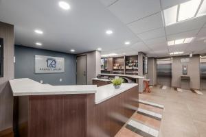 an office lobby with a reception desk and a bar at Coast Calgary Downtown Hotel & Suites by APA in Calgary