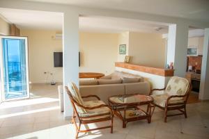a living room with a couch and chairs at Villa Edelweiss in Sveti Stefan