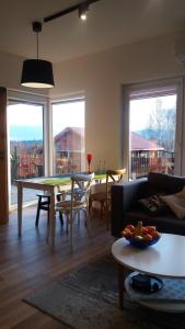 a living room with a table and a couch at Apartament Honey in Polanica-Zdrój