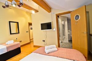 a hotel room with two beds and a television at Thames View House Surrey Quays in London