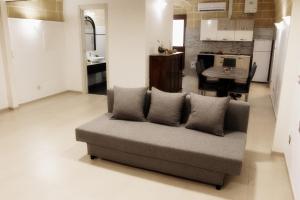 a living room with a couch and a kitchen at Daddy's house in Matera