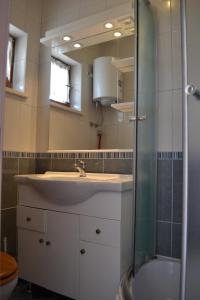 a bathroom with a sink and a shower at Villa Agava in Vrboska