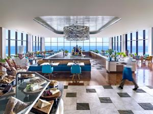 a rendering of a restaurant with a view of the ocean at Dusit Thani Guam Resort in Tumon