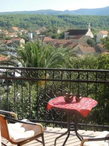 a table and chairs on a balcony with a view at Villa Agava in Vrboska