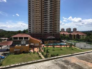 a building with a park in front of a building at D Savoy @ Famosa Melaka in Melaka