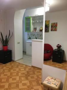 a room with a kitchen and a living room at Apartment Bombonyerka in Drogobych