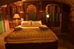 a bedroom with a bed and a lamp at The Arch Boutique Home stay in Jodhpur