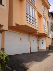 a building with two garage doors in front of it at Apartments Kira in Sarajevo