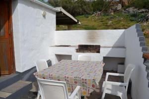 a table and chairs on a patio with a table and a table and chairs at Over The Mountain Guest Farm in George