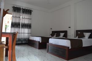 Ένα ή περισσότερα κρεβάτια σε δωμάτιο στο Blue Wings Beach Hotel