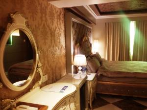 Postel nebo postele na pokoji v ubytování Hotel Oxina Lygon