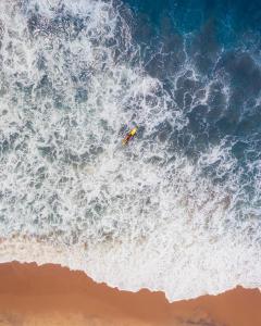 a surfer riding a wave in the ocean at Jetwing Surf in Arugam Bay