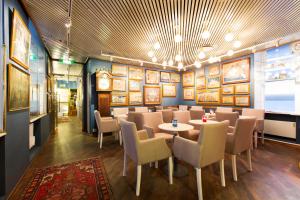a dining room with a table and chairs at Lord Nelson Hotel in Stockholm