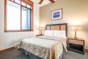 a bedroom with a bed with two lamps and a window at Village 2105 in Mammoth Lakes