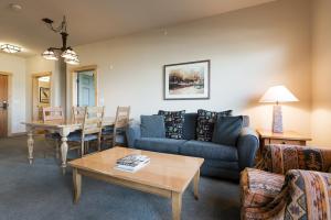 a living room with a couch and a table at Sunstone 325 in Old Mammoth