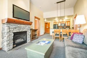 a living room with a fireplace and a tv at Village 2105 in Mammoth Lakes