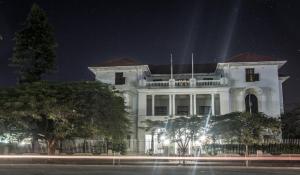 un bâtiment blanc avec des lumières devant lui la nuit dans l'établissement Bulawayo Club, à Bulawayo