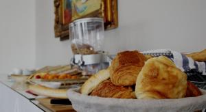 a bowl of bread and pastries on a table at Saglam Hôtel in Goussainville