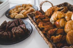 a bunch of different types of pastries on a table at Island Boutique Hotel in Larnaca