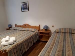 Posteľ alebo postele v izbe v ubytovaní Hotel Fiames