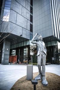 a statue of a woman standing in front of a building at GLAD Gangnam COEX Center in Seoul