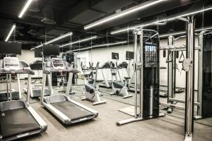 a gym with several treadmills and elliptical machines at GLAD Gangnam COEX Center in Seoul